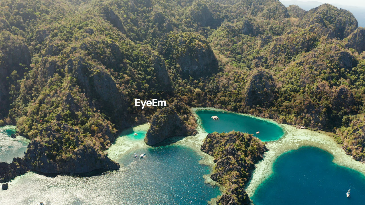 Aerial drone lagoons and coves with blue water among the rocks. palawan, philippines, busuanga