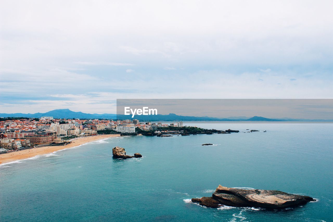 Rock formation in sea against sky