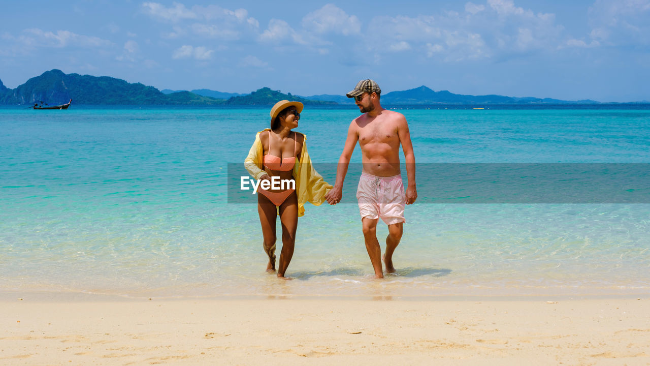 rear view of man standing at beach