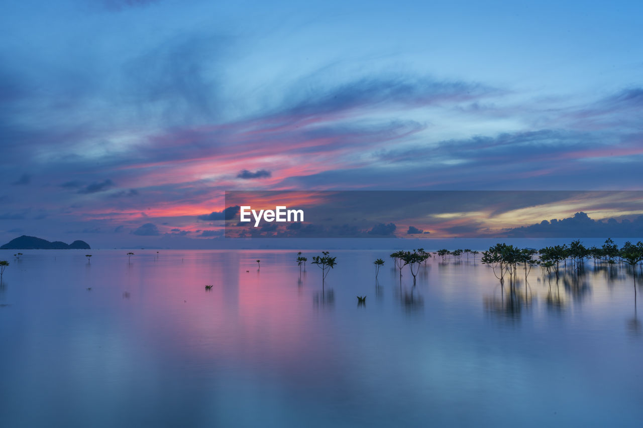 Scenic view of sea against sky at sunset