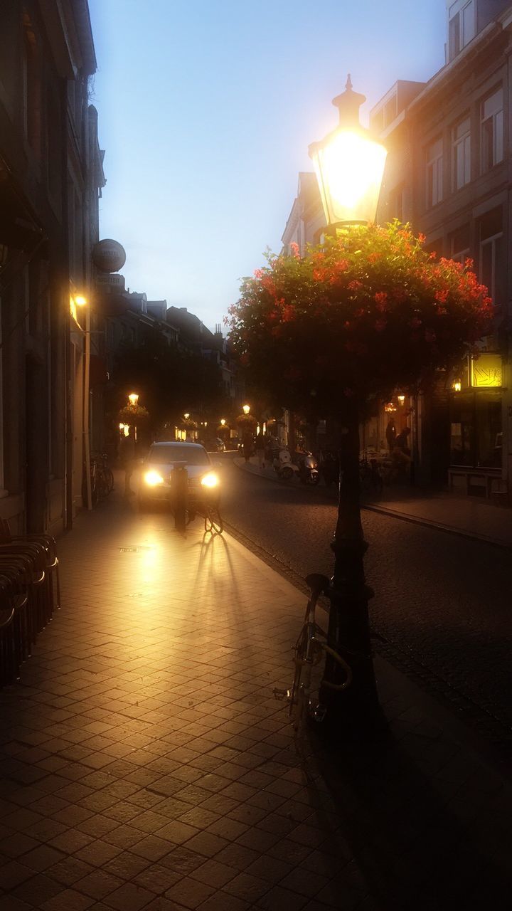 VIEW OF ILLUMINATED STREET LIGHTS AT NIGHT