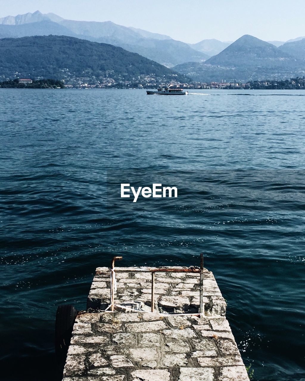 Abandoned pier over lake against mountains