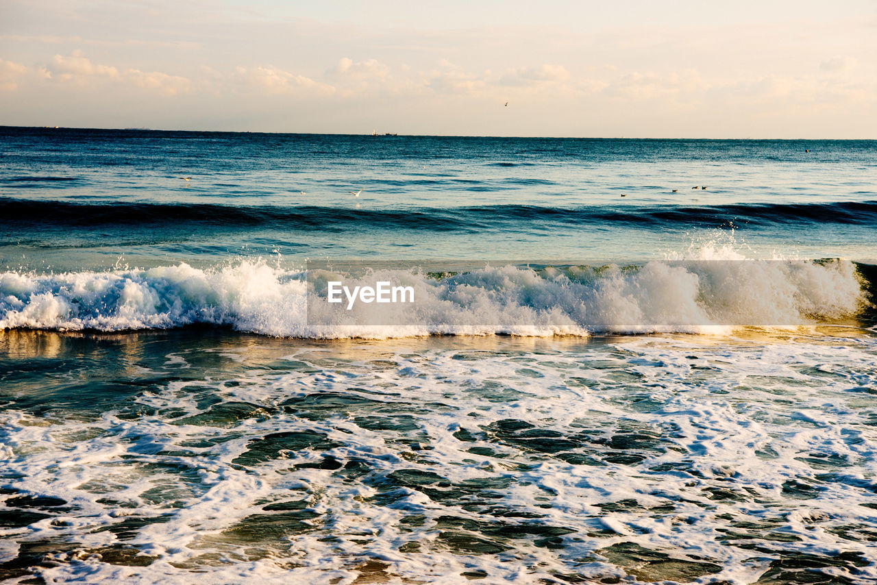 SCENIC VIEW OF SEA WAVES AGAINST SKY