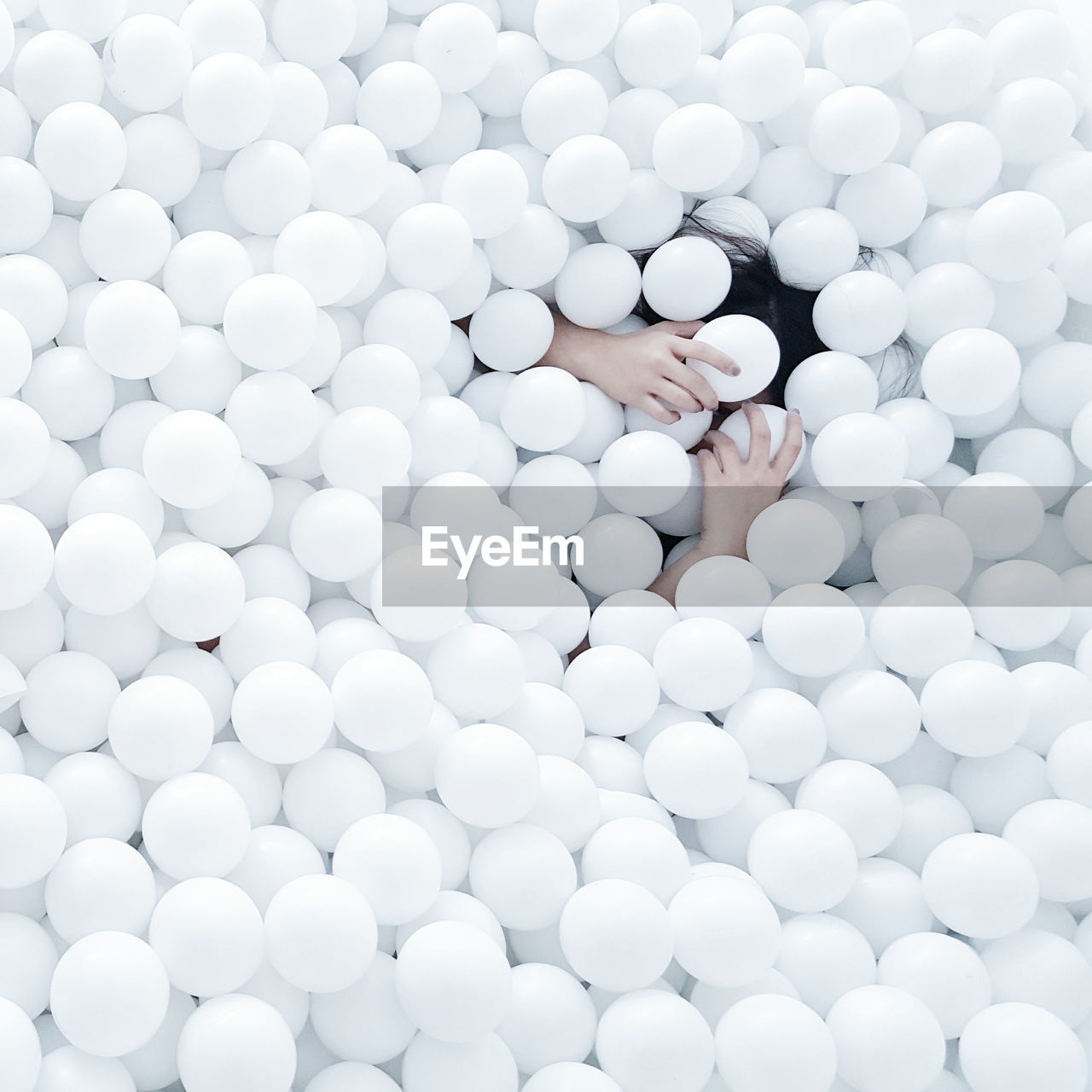 High angle view of woman enjoying in white ball pool