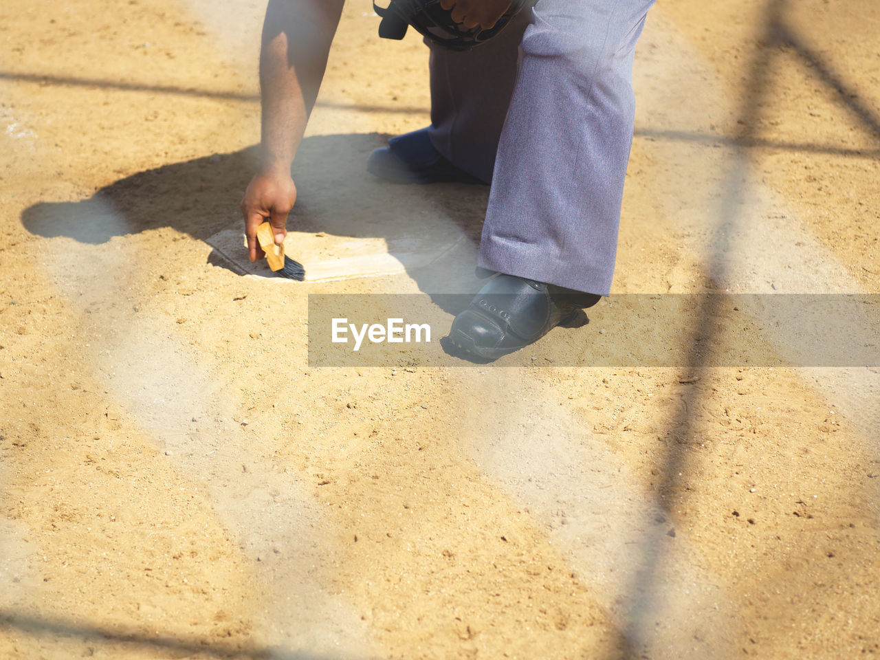Low section of man making marking on ground