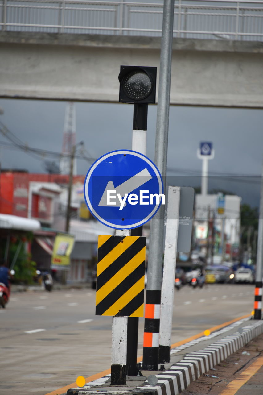 ROAD SIGN AGAINST BUILDINGS