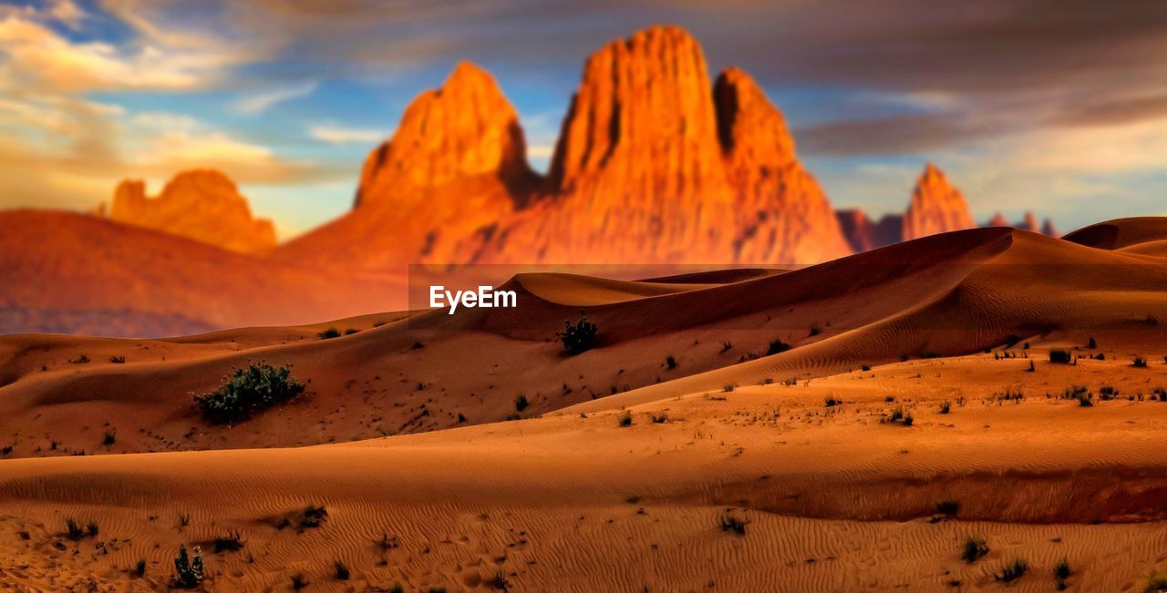 Scenic view of desert against sky during sunset