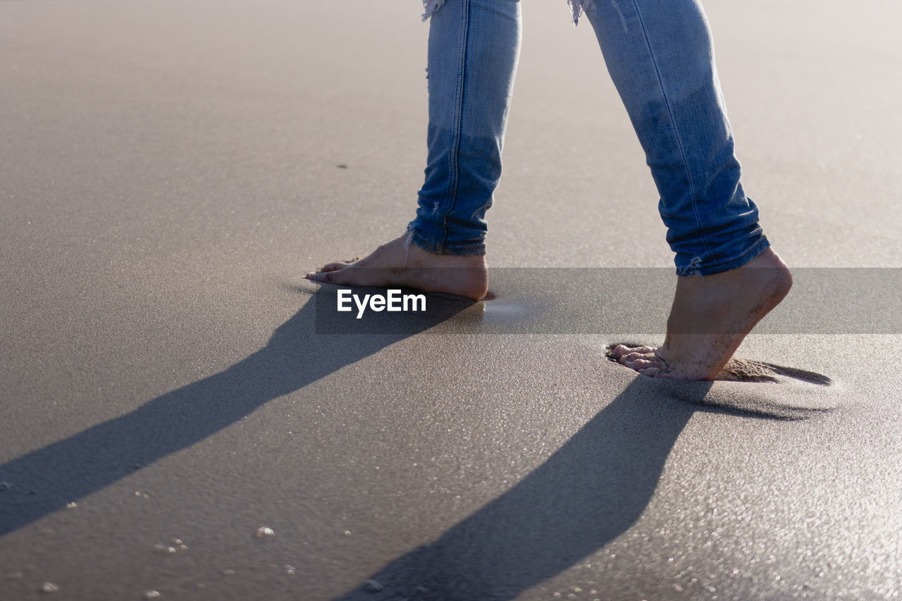 Man walking barefoot on the beach