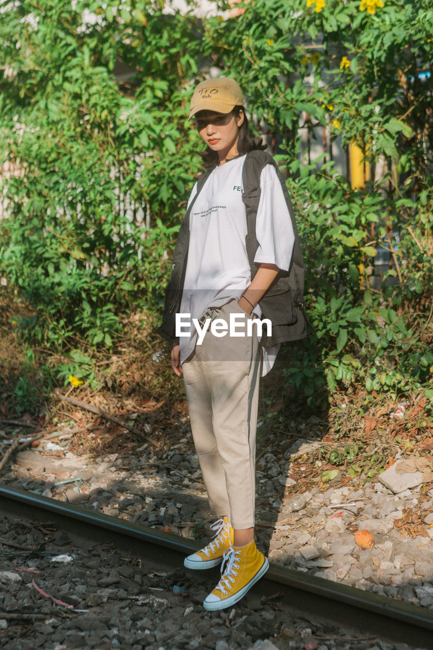 full length of young man standing on footpath