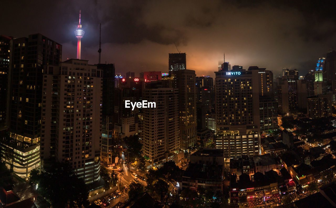 Illuminated menara kuala lumpur tower in city at night