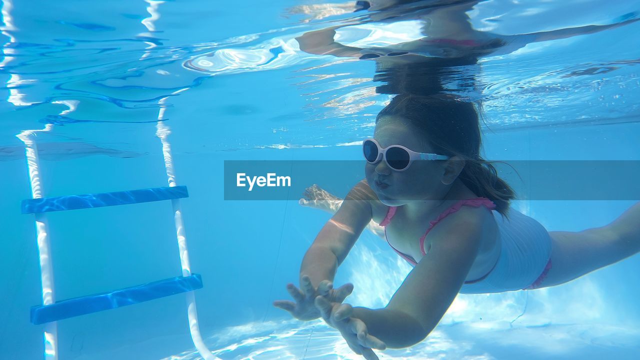 underwater, water, swimming, sea, nature, women, swimwear, one person, adult, swimming pool, sports, blue, water sports, female, undersea, eyewear, child, swimming goggles, underwater diving, young adult, portrait, adventure, vacation, trip, holiday, outdoors, summer, lifestyles, clothing, childhood, sunlight, leisure activity, scuba mask, snorkeling, full length, bikini, front view, scuba diving