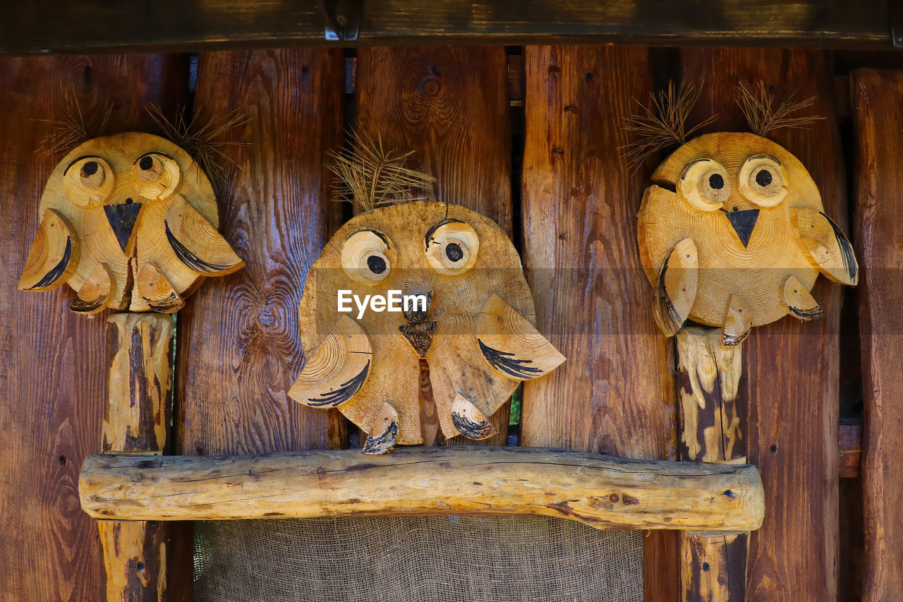 CLOSE-UP OF STUFFED TOY HANGING ON WOOD IN SHELF