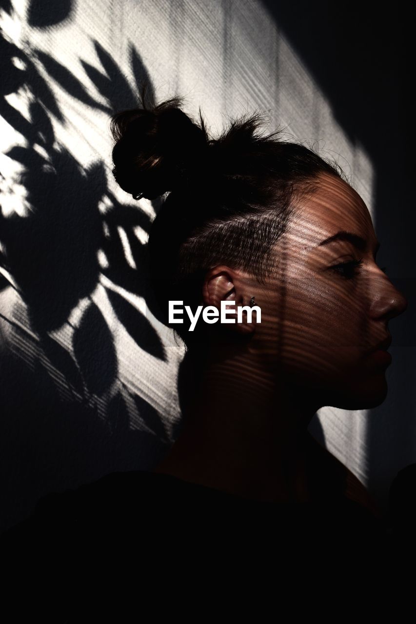 Side view of woman in darkroom