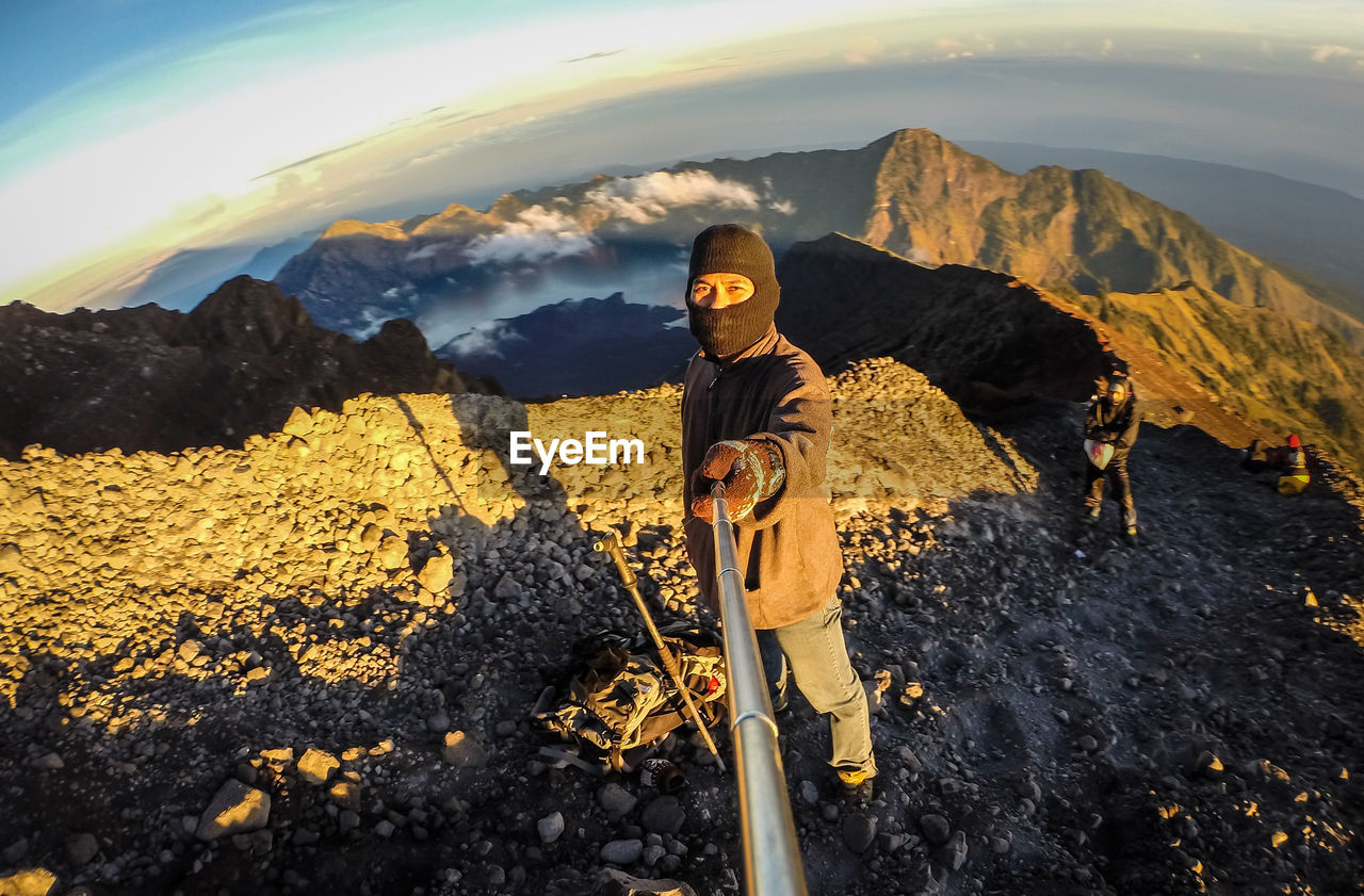 Man clicking selfie while standing on mountain