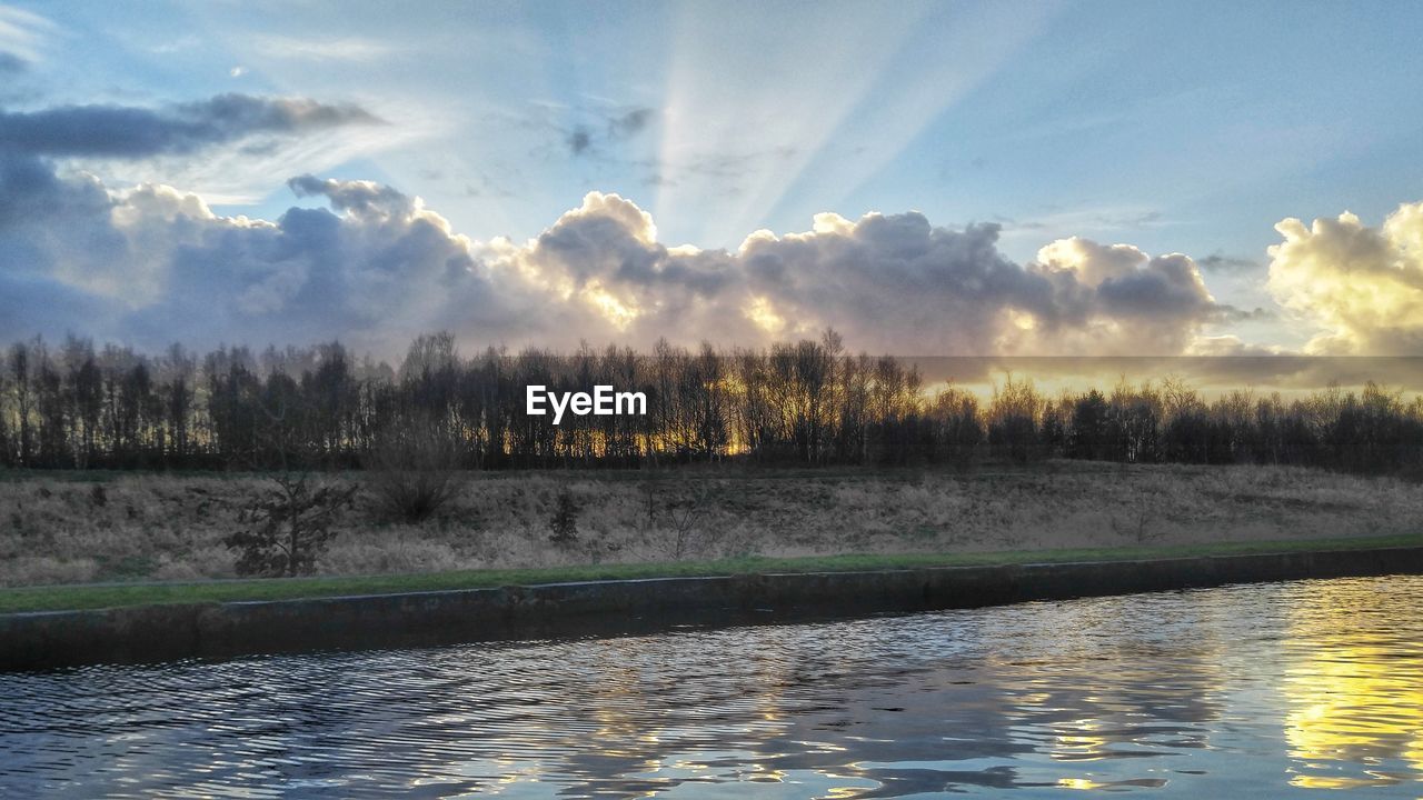 SCENIC VIEW OF LAKE BY TREES AGAINST SKY