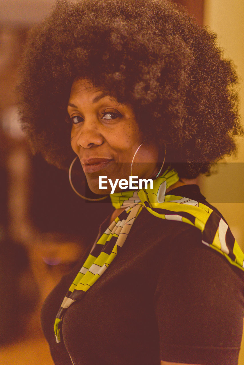 Portrait of woman with curly hair at home