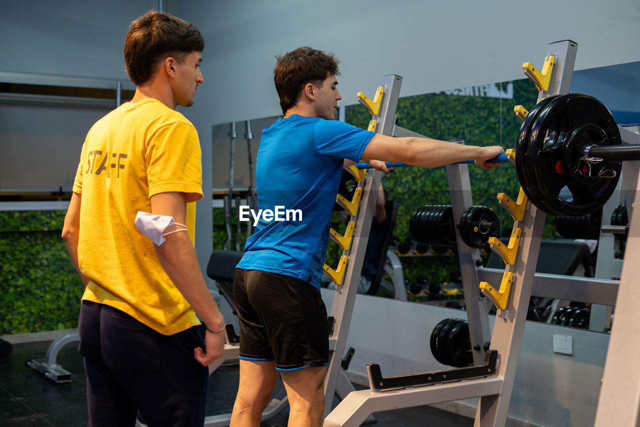 Rear view of man standing in gym