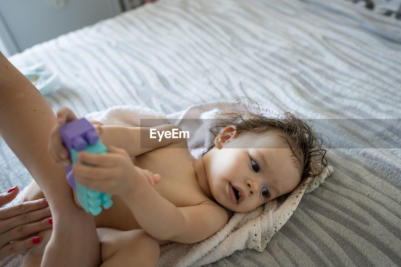 high angle view of young woman sleeping on bed at home