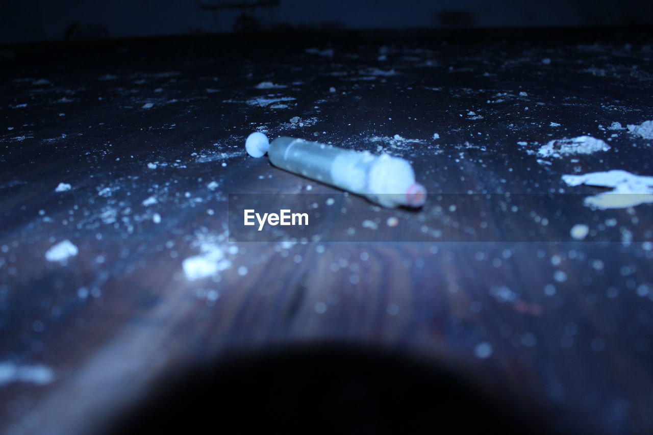 Syringe on dirty table at home