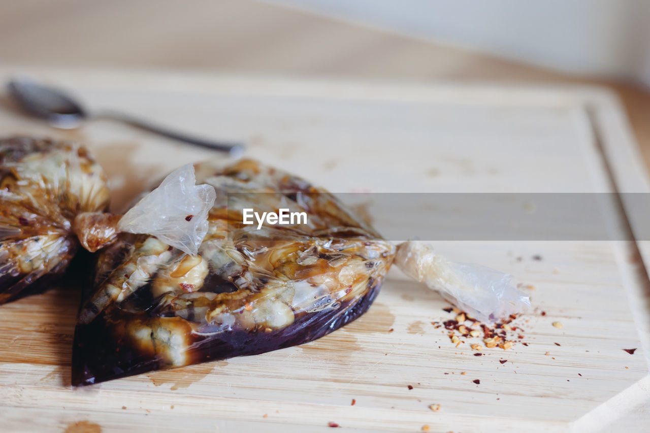 CLOSE-UP OF MEAT ON TABLE