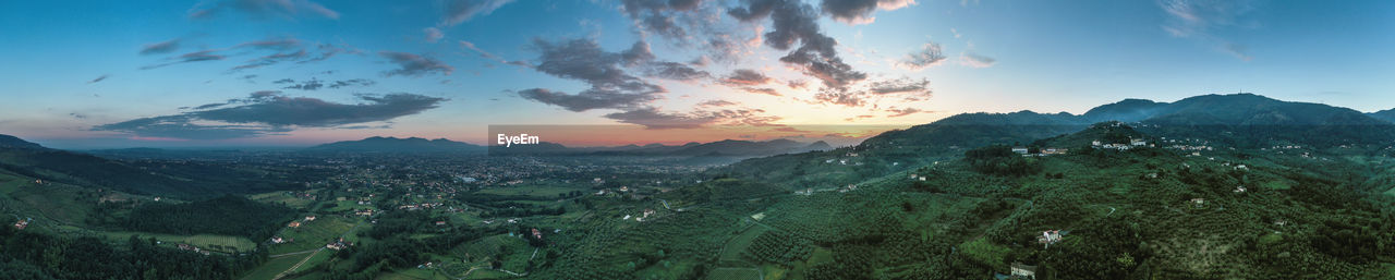 Scenic view of winyards of tuscany against sky during sunset