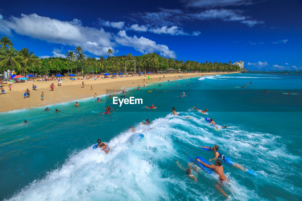 PEOPLE ENJOYING AT BEACH