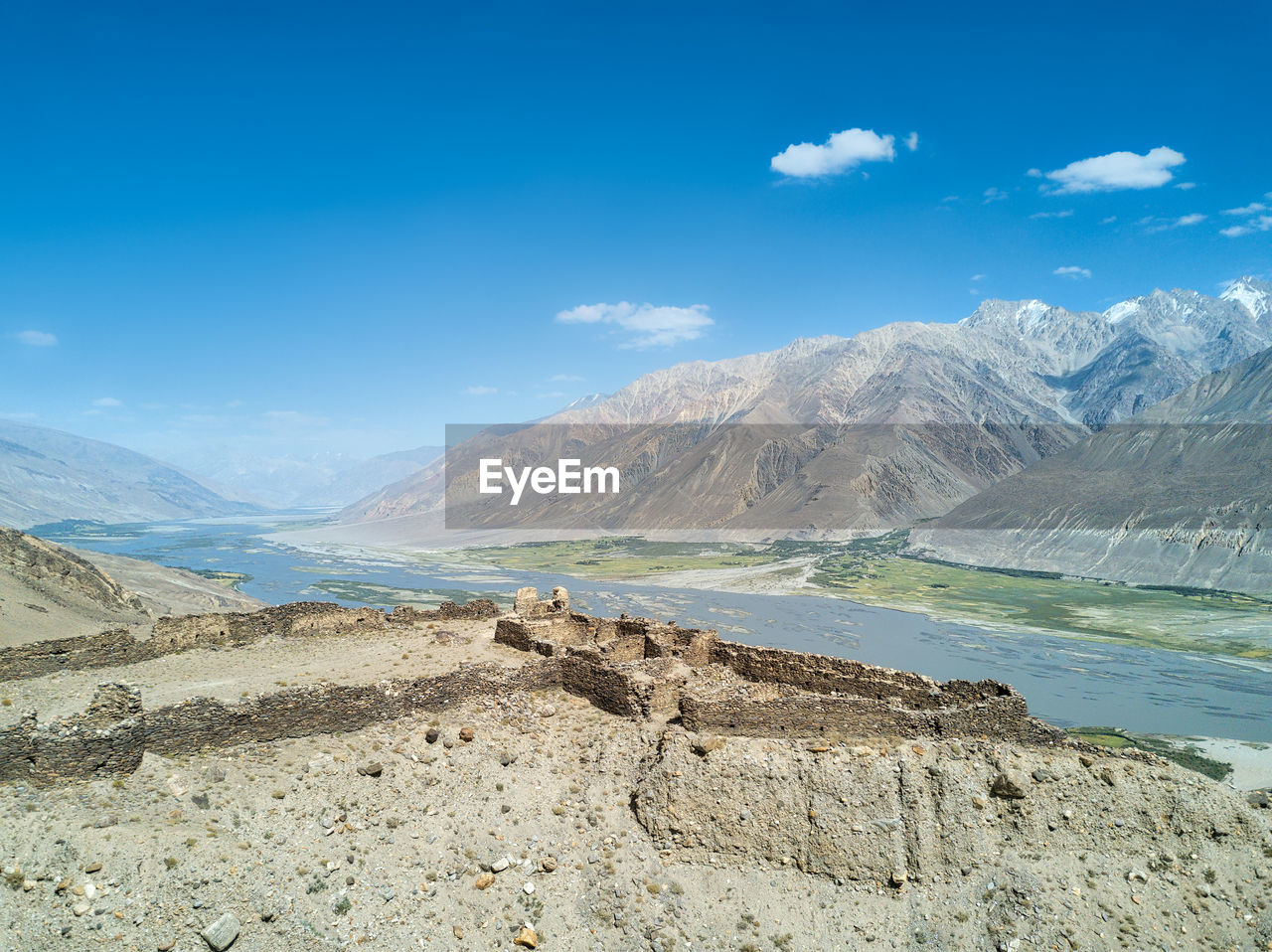 Scenic view of landscape and mountains against blue sky