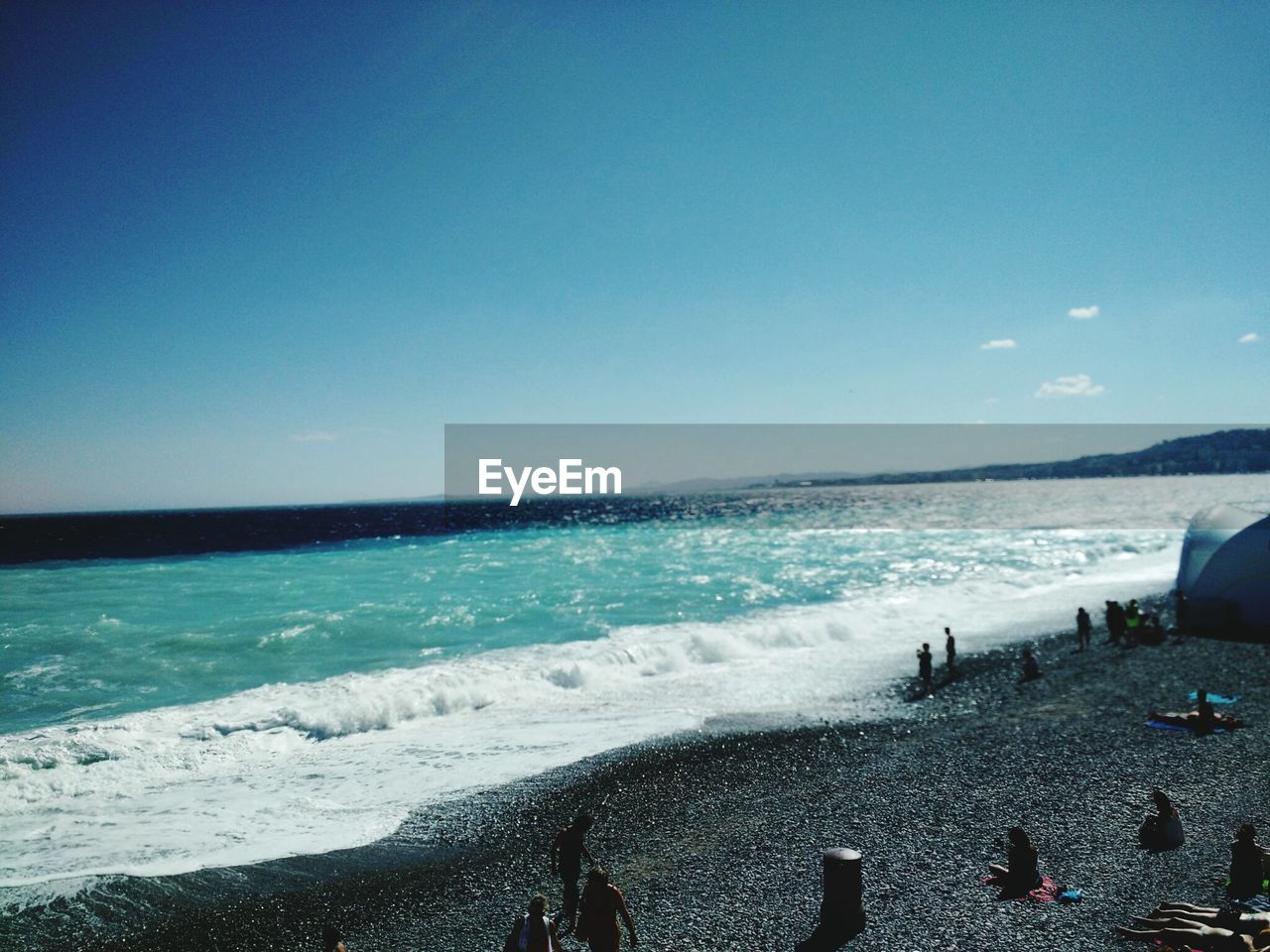 VIEW OF BEACH AGAINST BLUE SKY