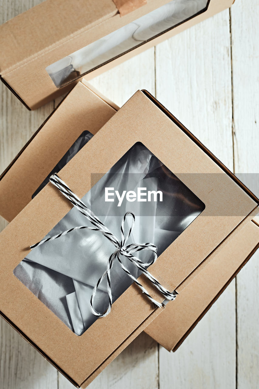 box, cardboard, wood, cardboard box, container, indoors, high angle view, paper, no people, gift, lighting, still life, table, wedding favors, gift box, package, close-up
