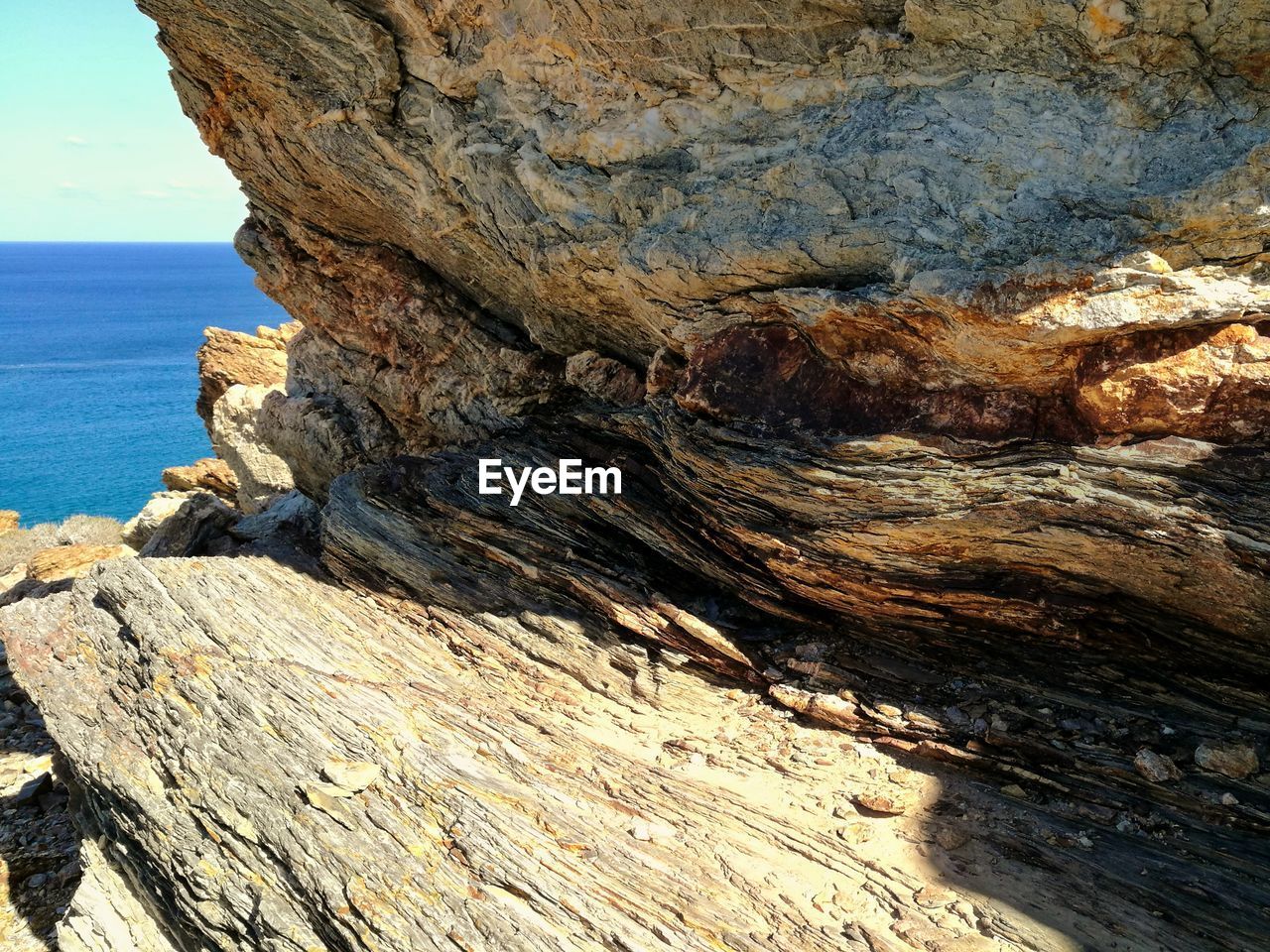 CLOSE-UP OF ROCK FORMATIONS IN SEA