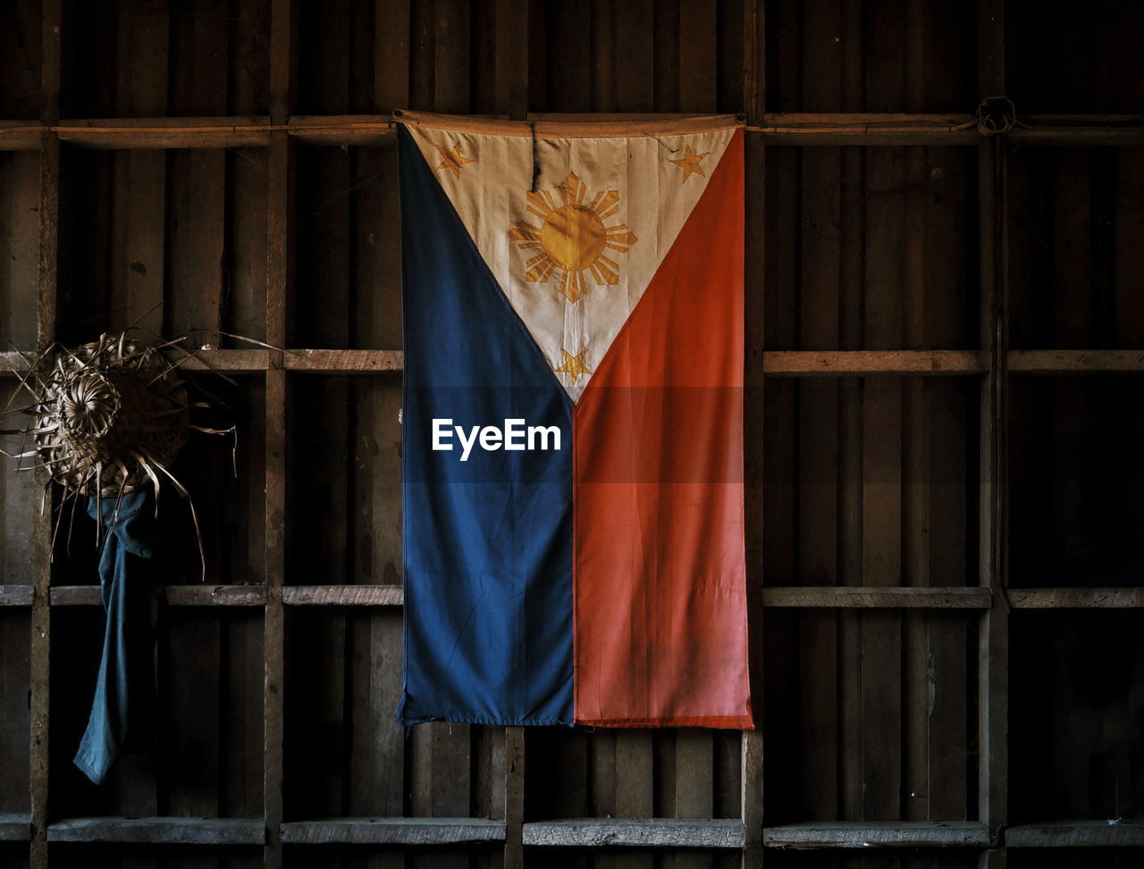 Philippines flag hanging from wooden wall