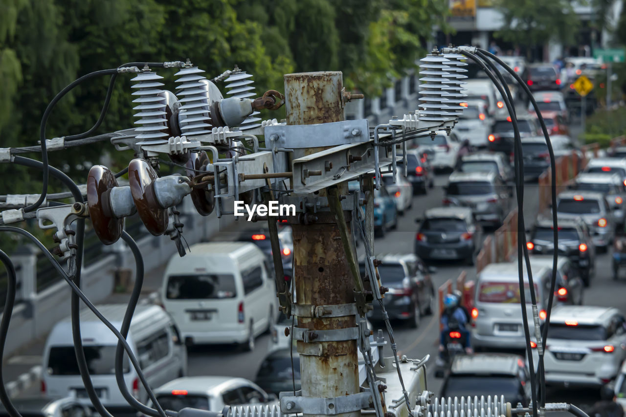 Electrical installation in the middle of a big city with a vehicle background