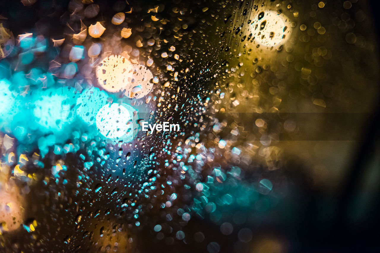 Full frame shot of wet car window at night