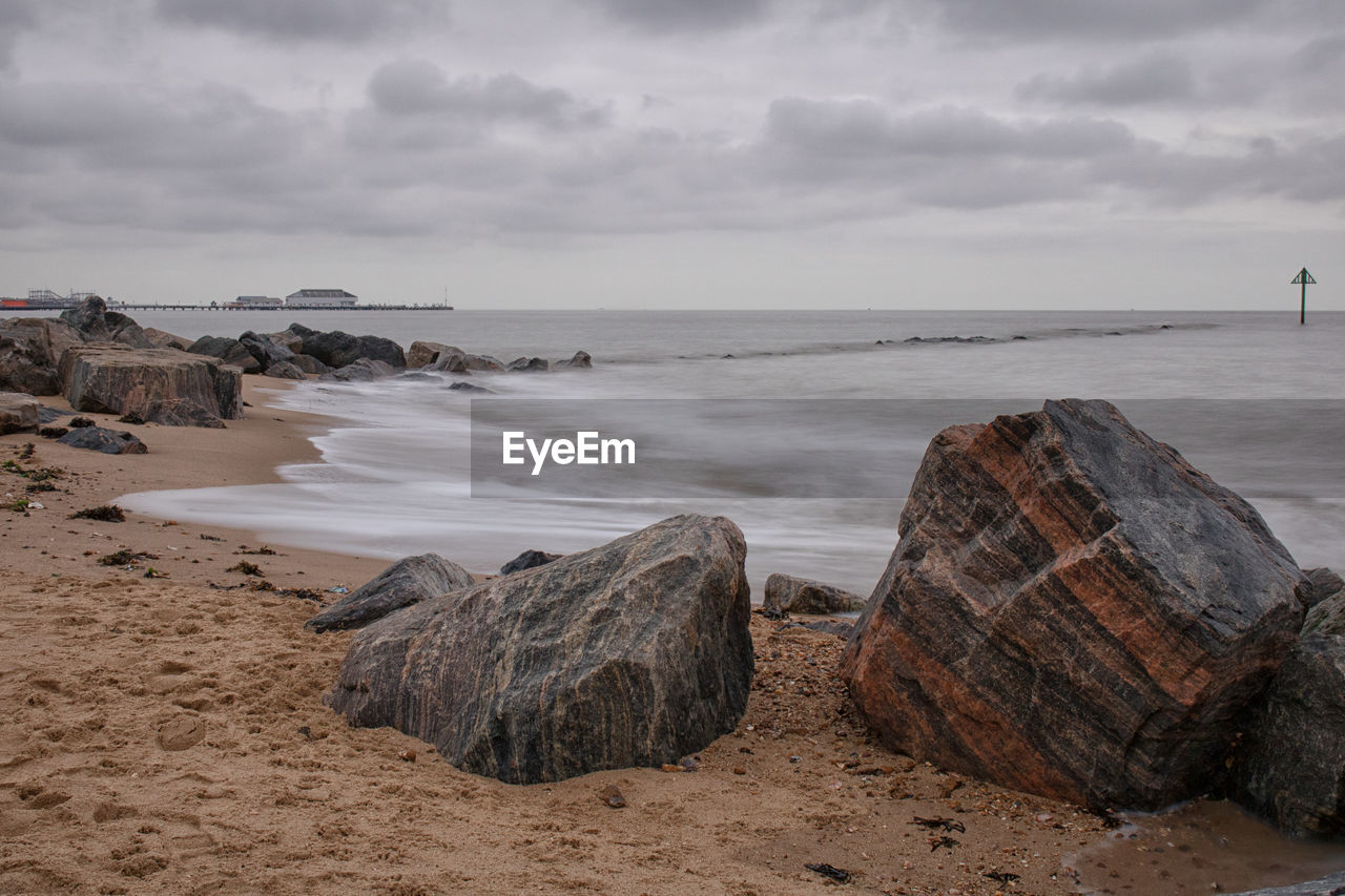 Rocks on beach against sky