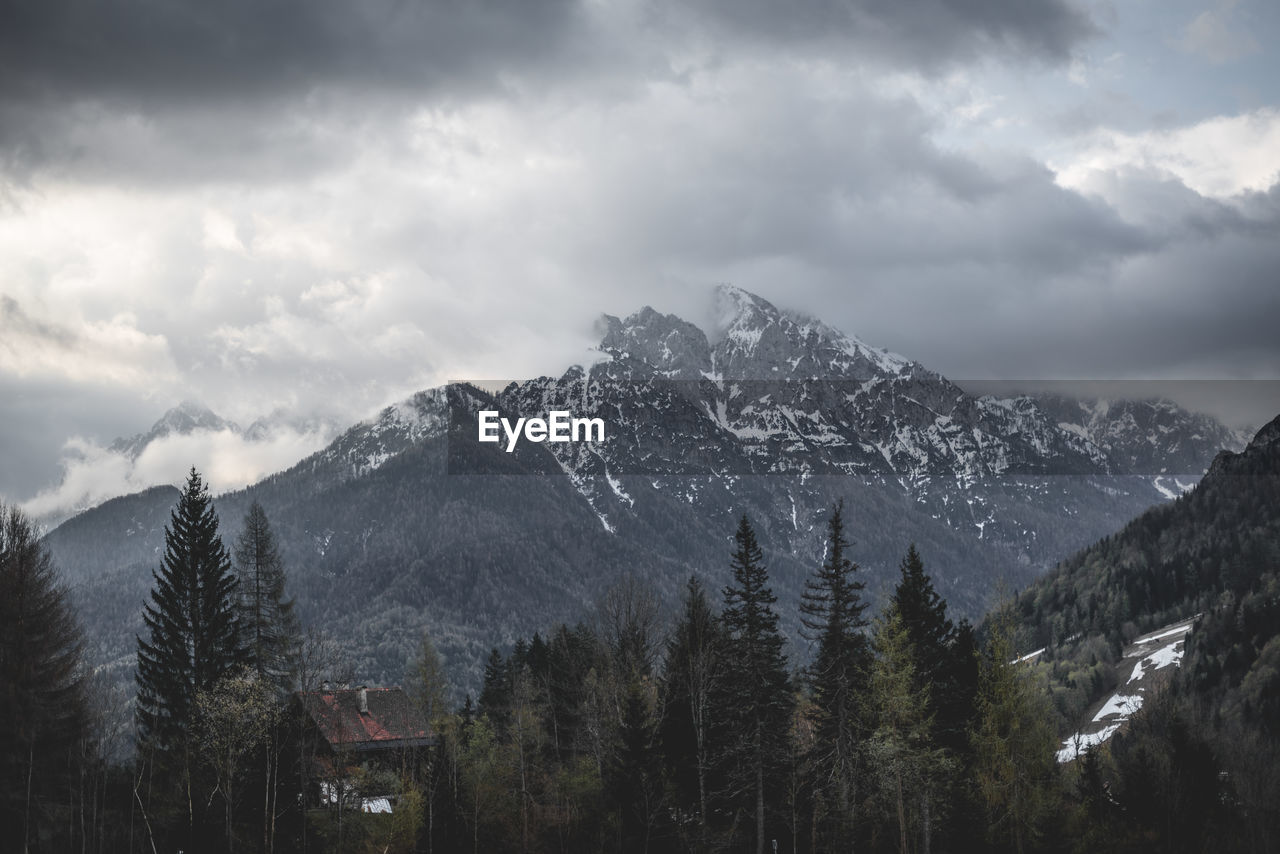 Scenic view of mountains against cloudy sky