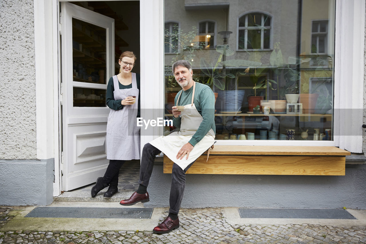 Portrait of confident male and female coworkers at art studio