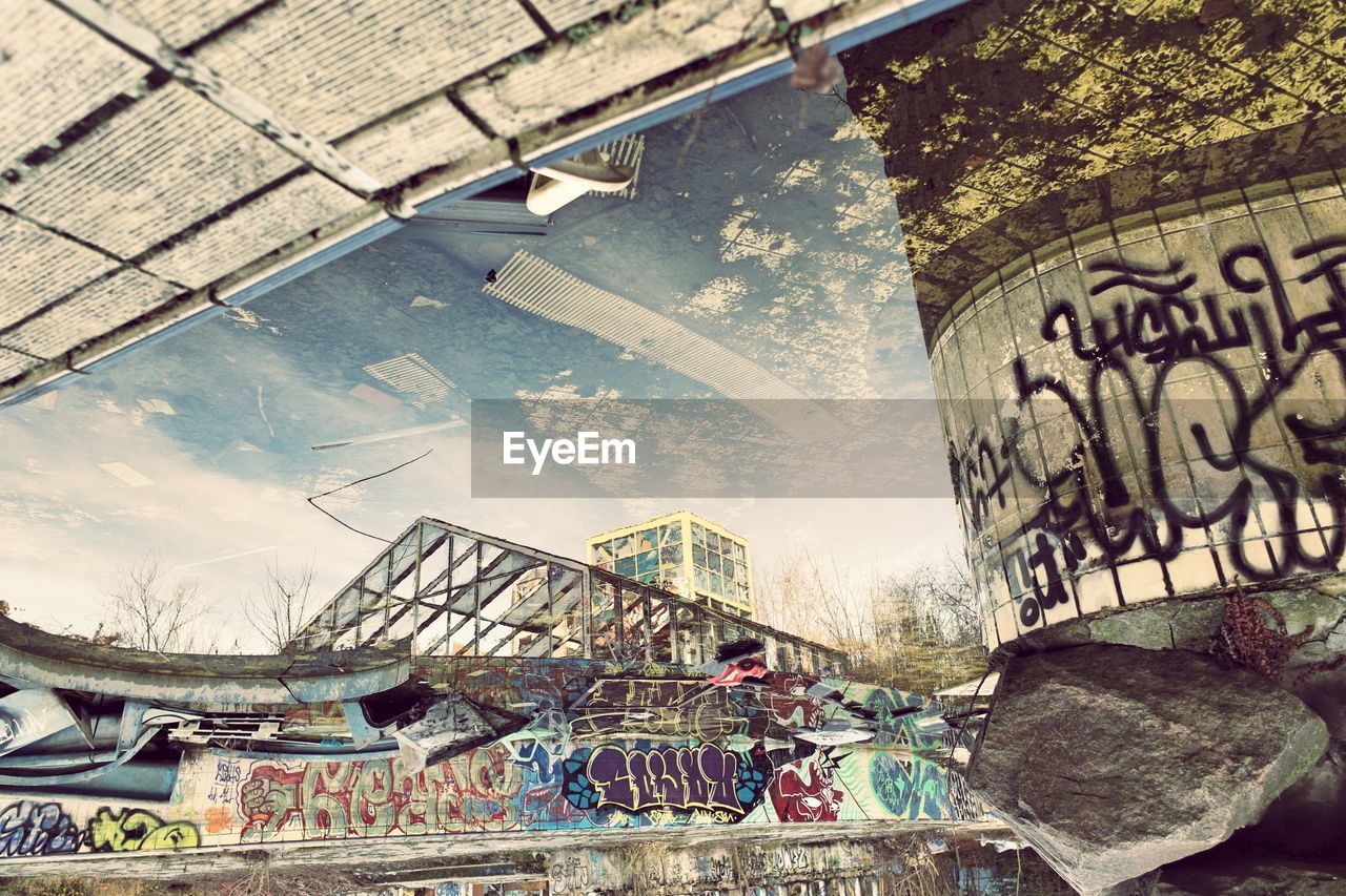 Upside down image of buildings reflecting on pool