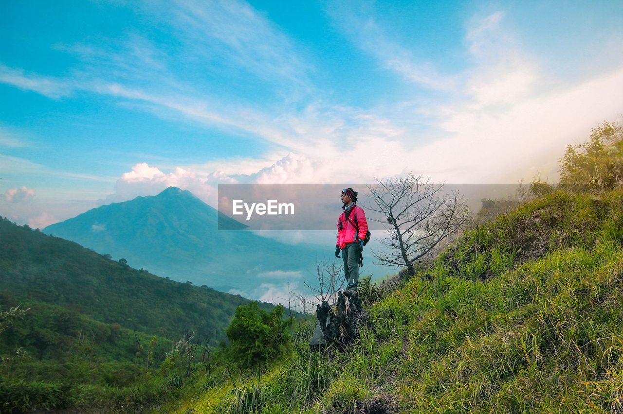 Man standing on mountain against sky