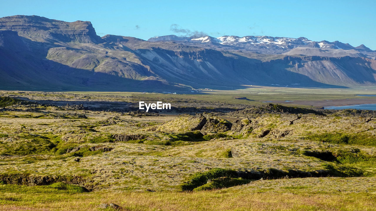 Scenic view of landscape and mountains against sky at raudfeldsgja gorge