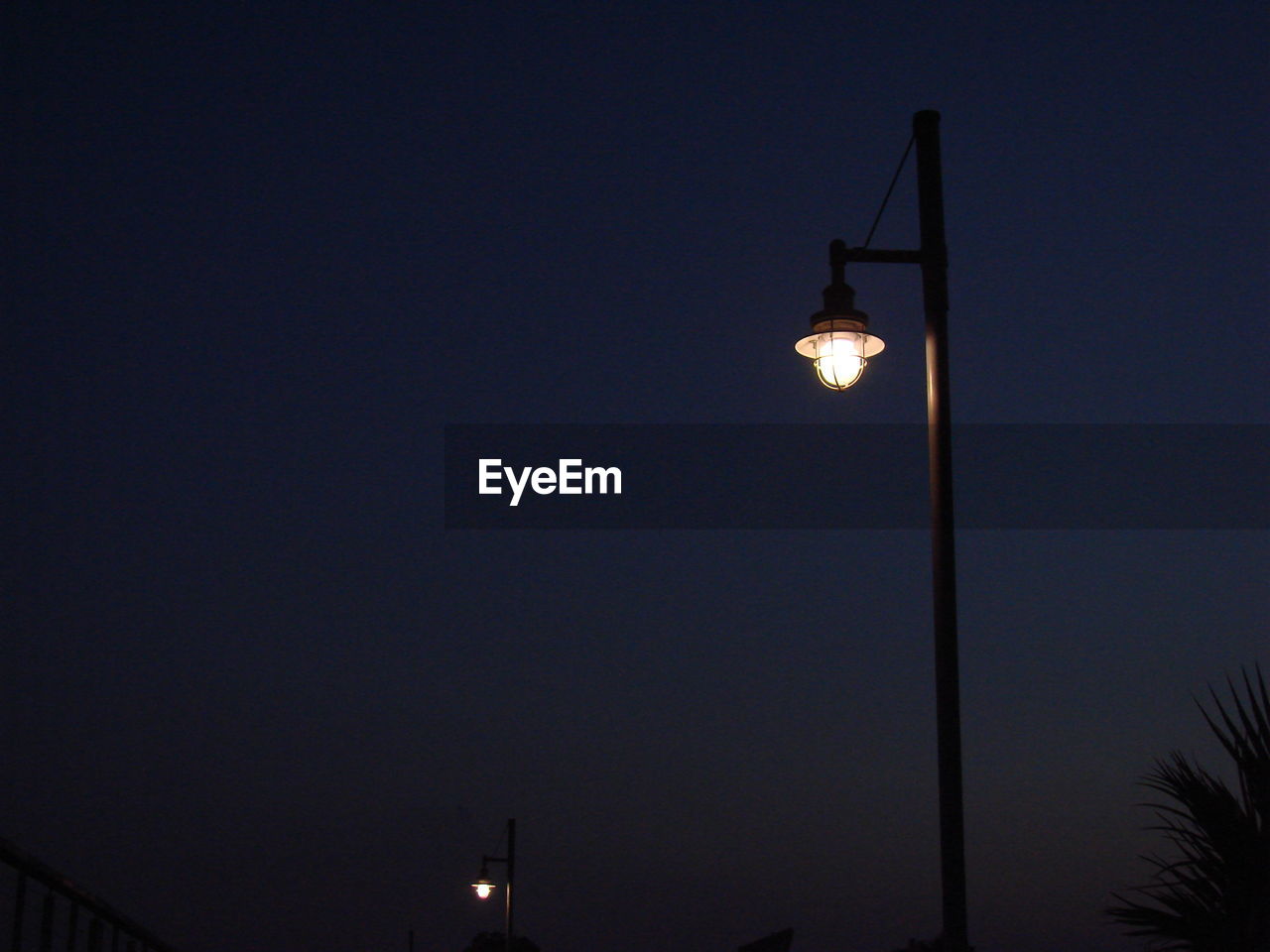 LOW ANGLE VIEW OF STREET LIGHT AT NIGHT