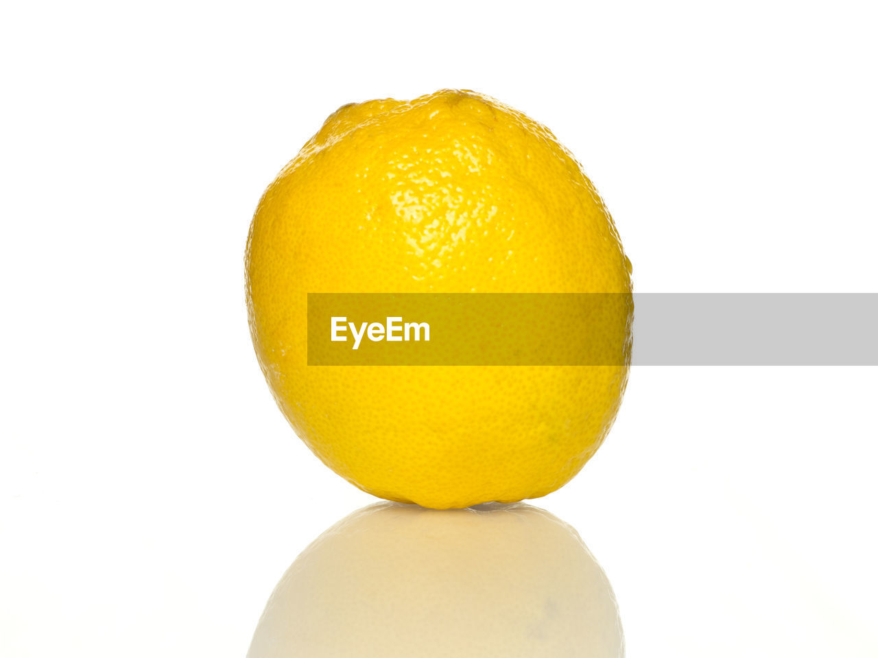 Close-up of lemon over white background