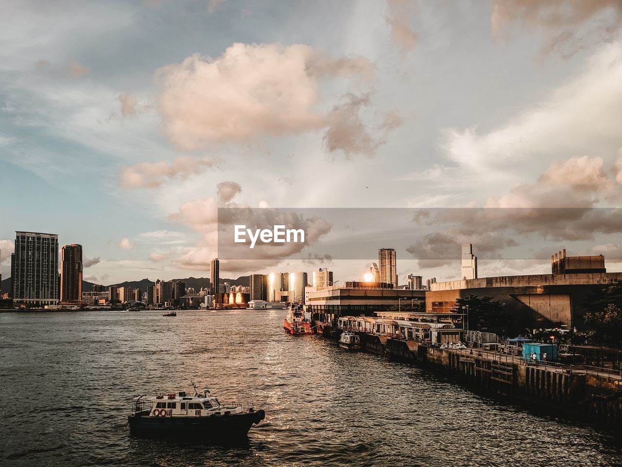 Scenic view of river by buildings against sky