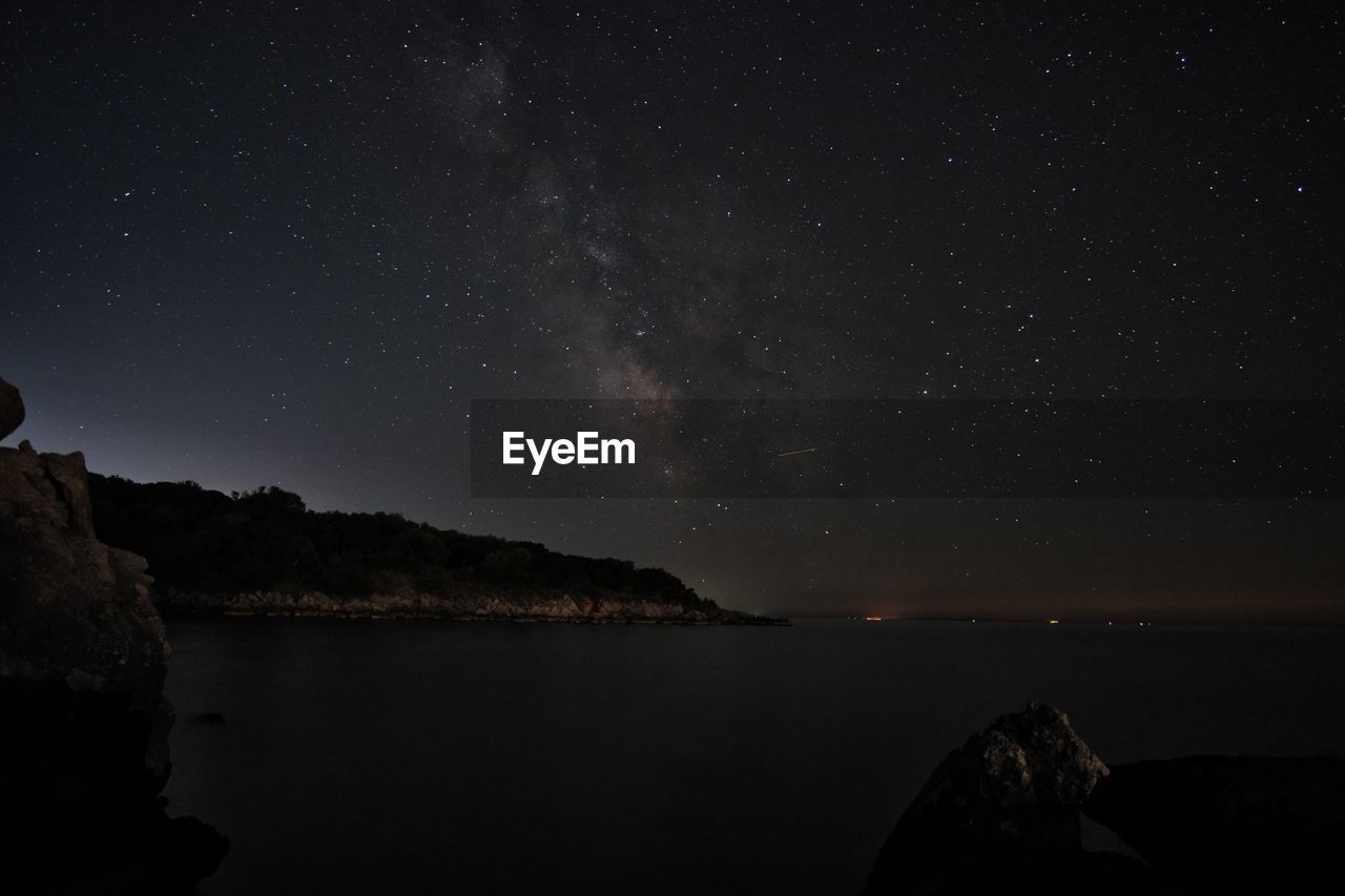 Scenic view of sea against sky at night