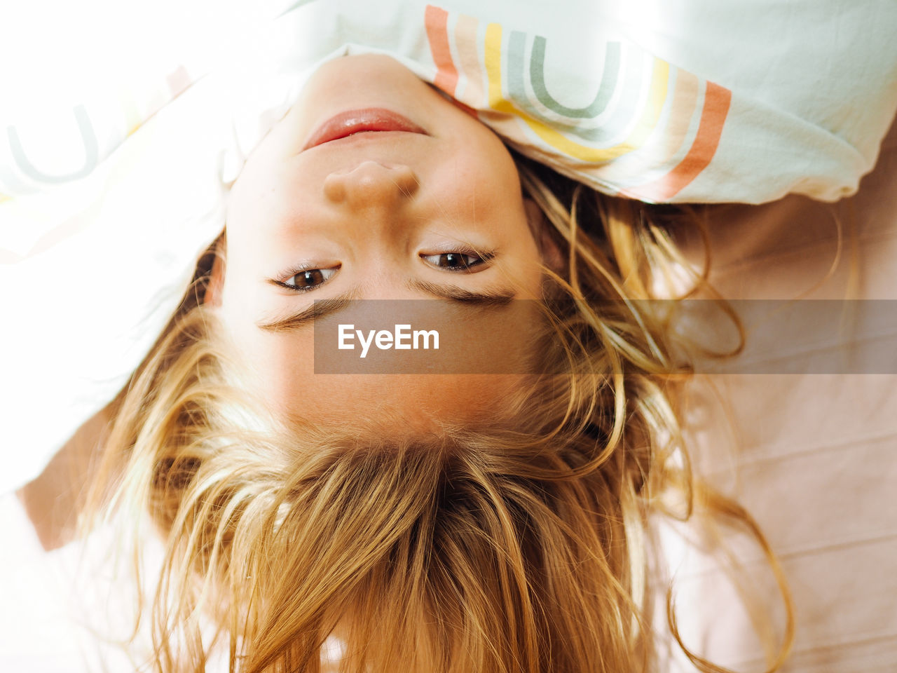 Portrait of cute baby lying on bed at home