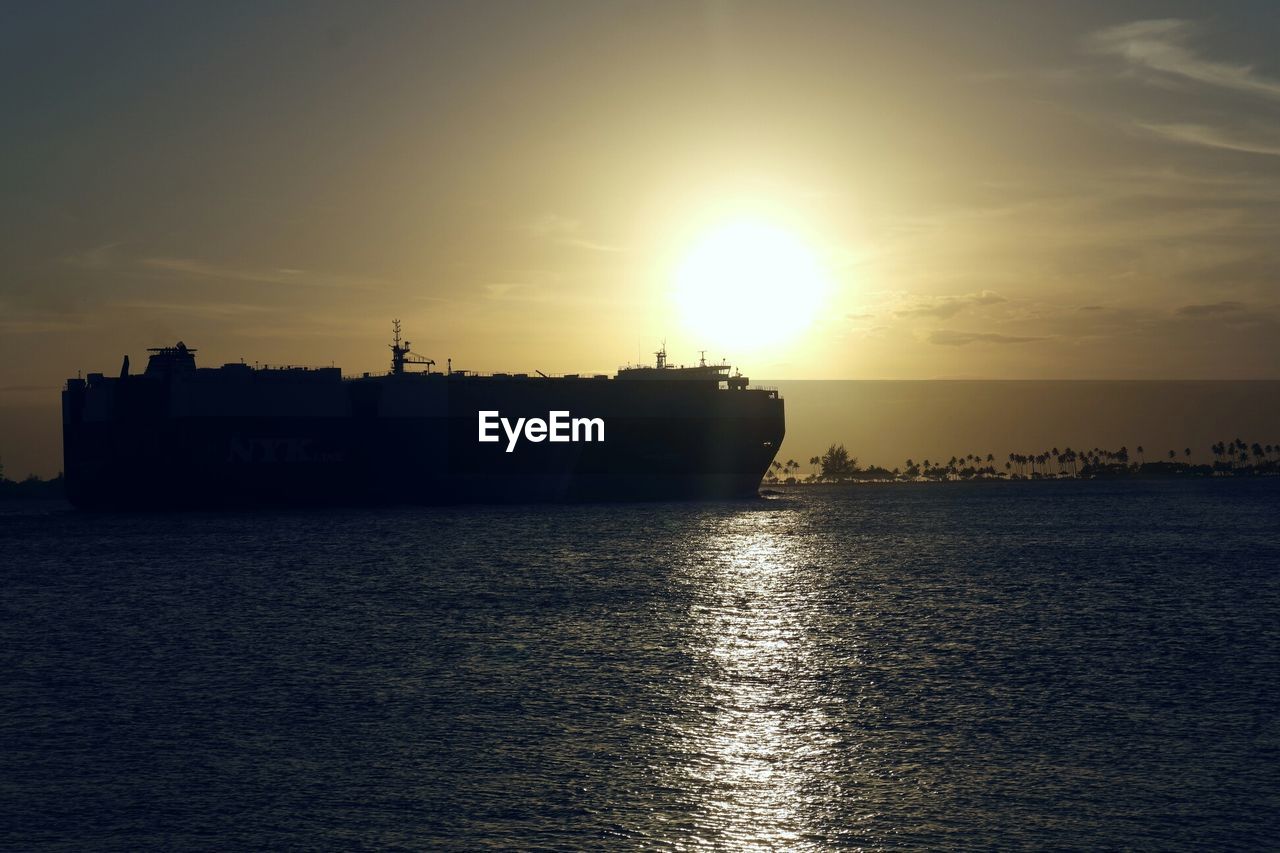 Silhouette ship sailing on sea against sky during sunset