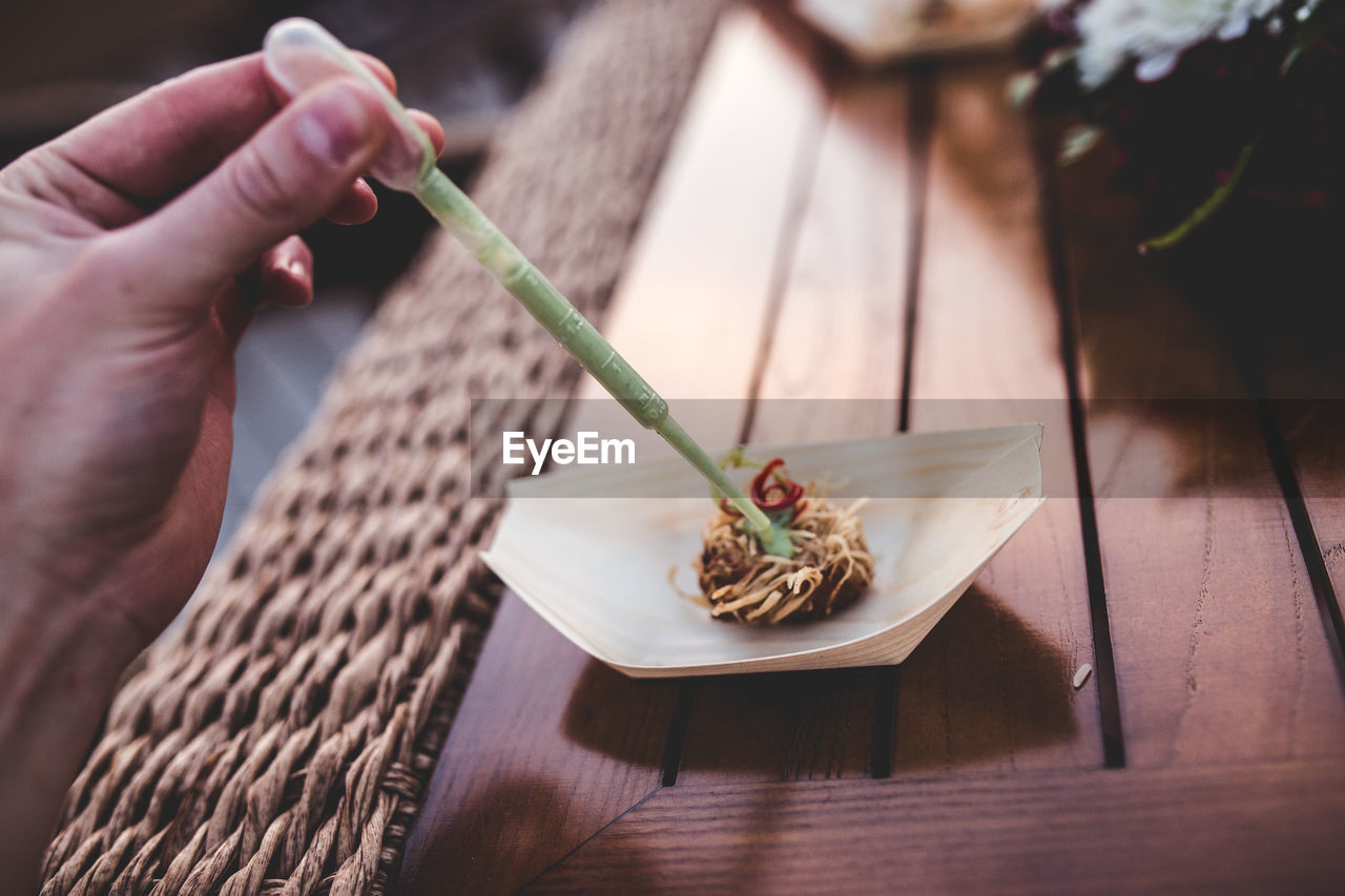 Cropped hand of woman making food