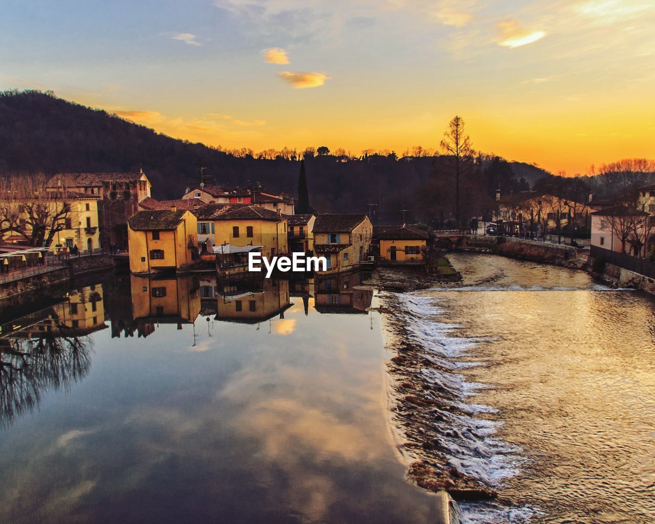 Buildings in city at sunset