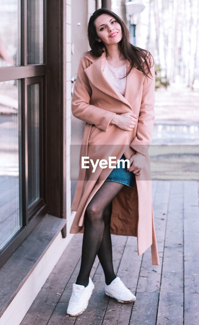 Portrait of woman standing on boardwalk