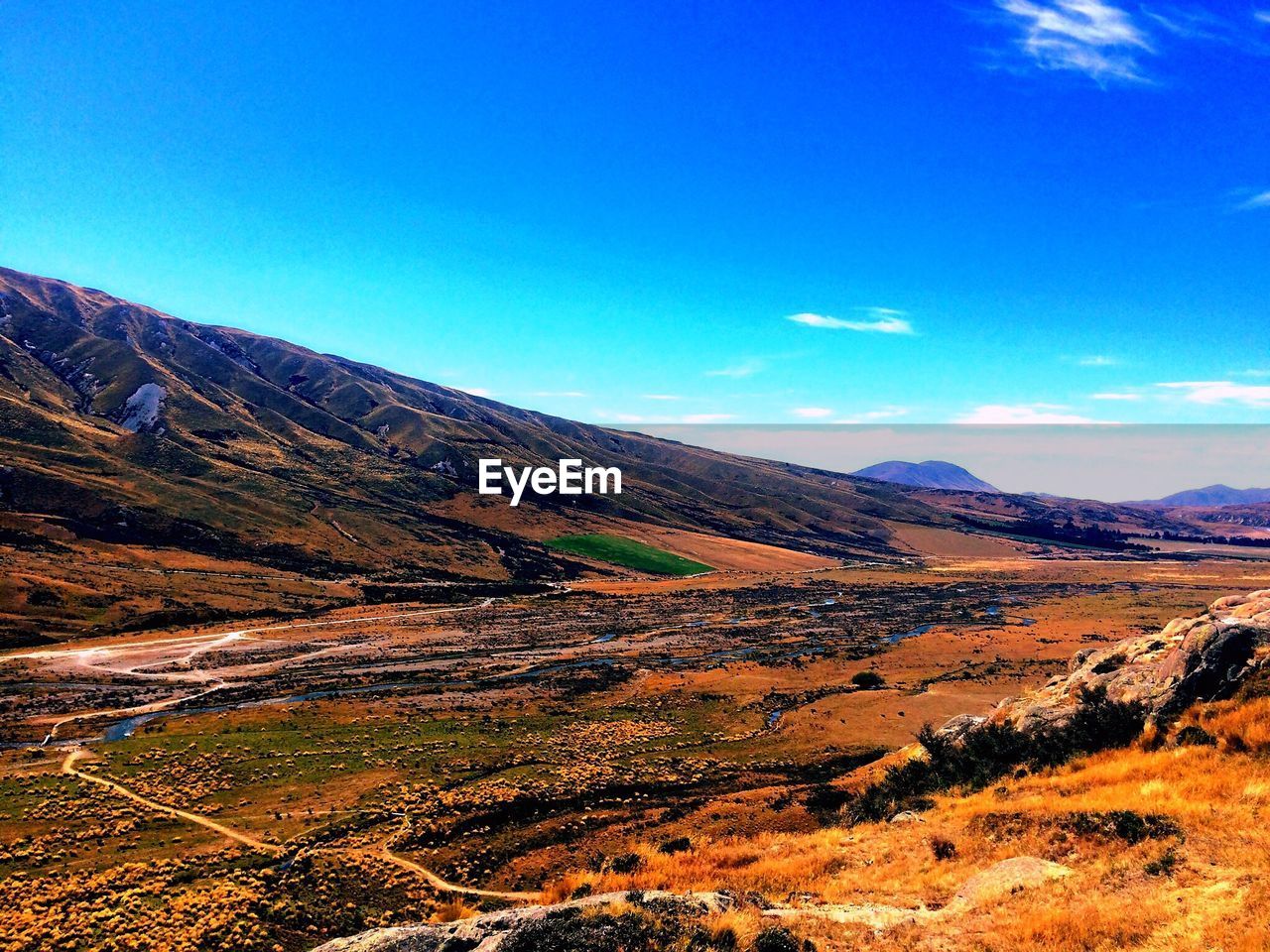 SCENIC VIEW OF MOUNTAIN AGAINST BLUE SKY