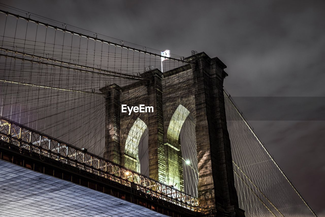 Low angle view of illuminated brooklyn bridge against sky at night